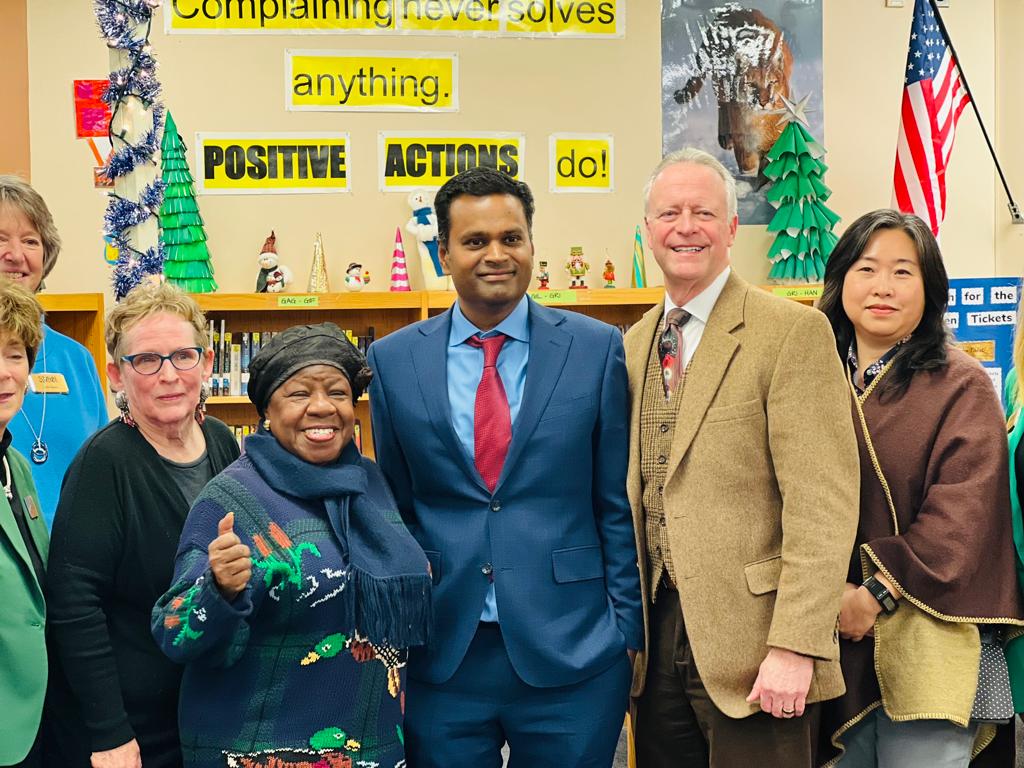 Educators and guests standing together in a school library